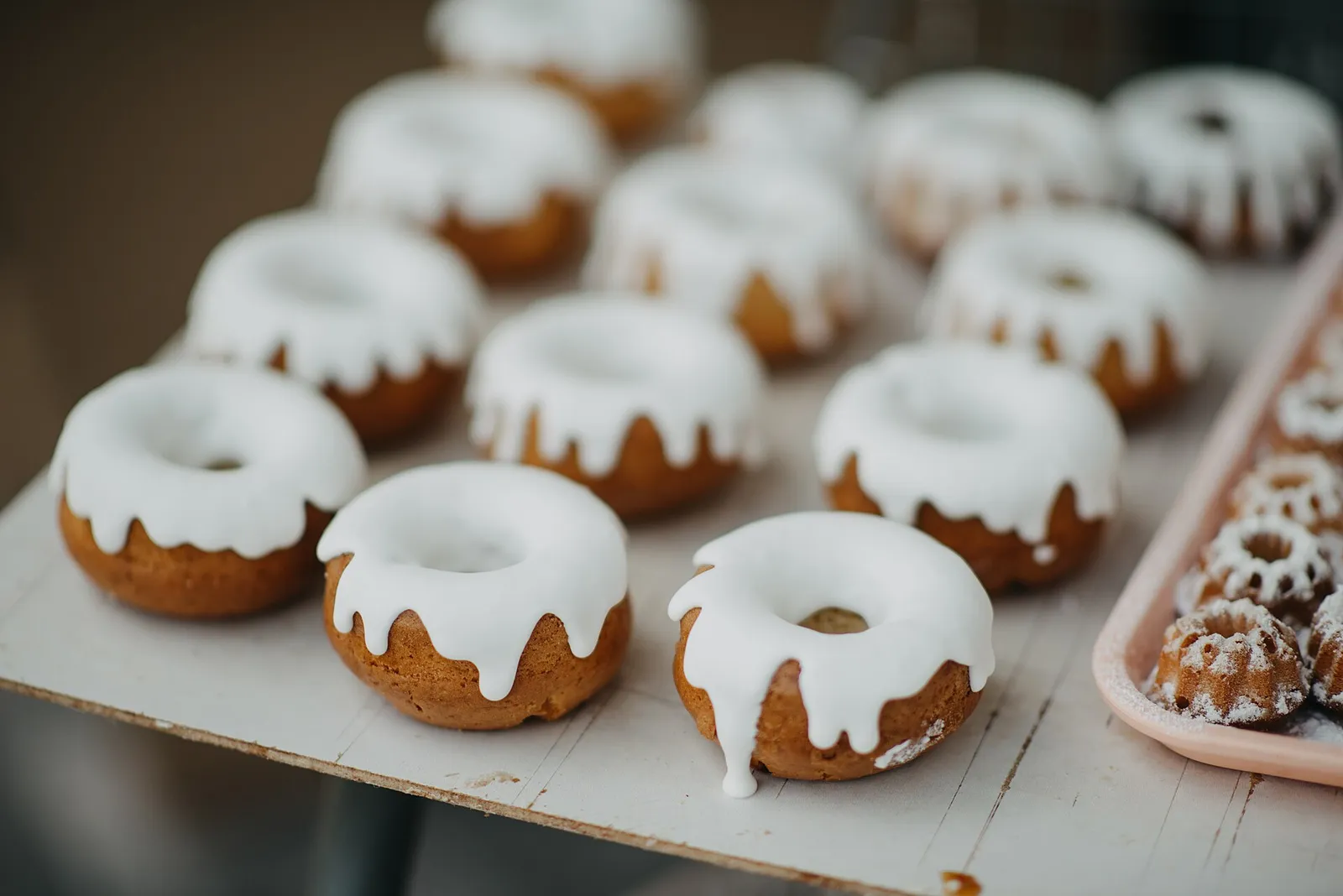Frosted doughnuts on a bakery tray. The photo was not taken in Columbus.