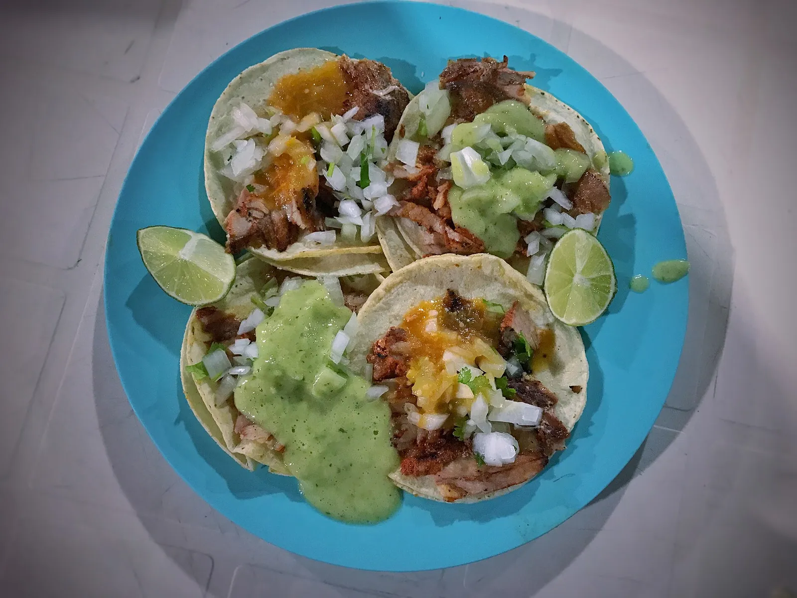 Al pastor tacos with lime and salsa. The photo was not taken at a Columbus restaurant.
