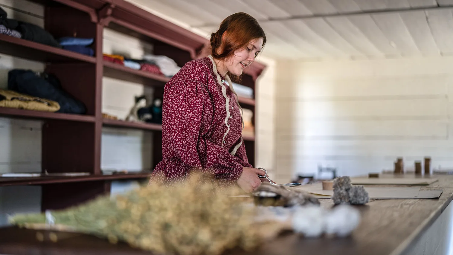 A dressmaking interpreter at work in a shop at Historic Westville on South Lumpkin Road in Columbus.