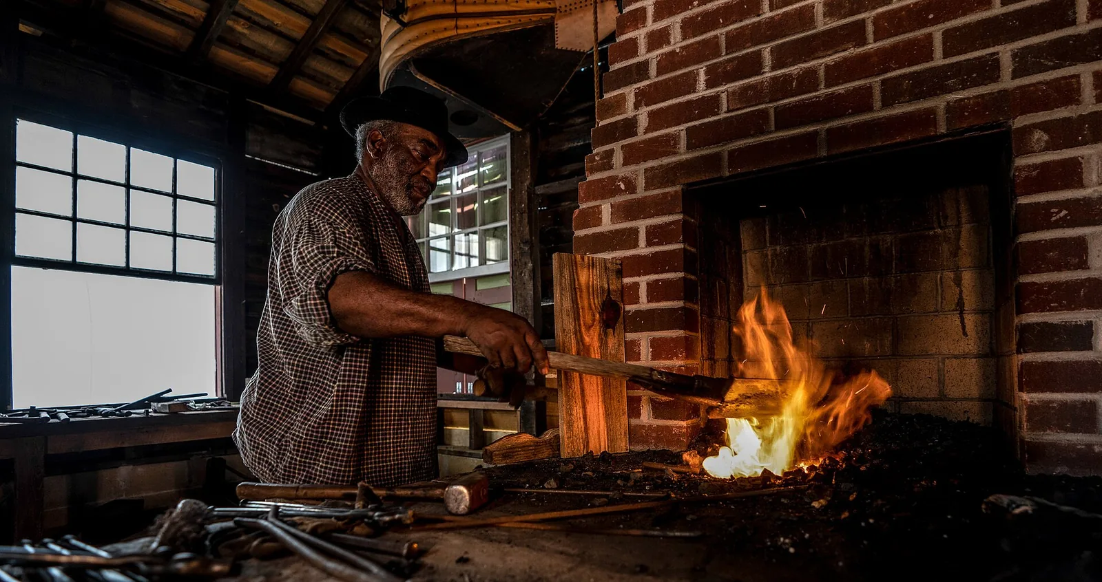 A blacksmith at work at the forge at Historic Westville on South Lumpkin Road in Columbus.