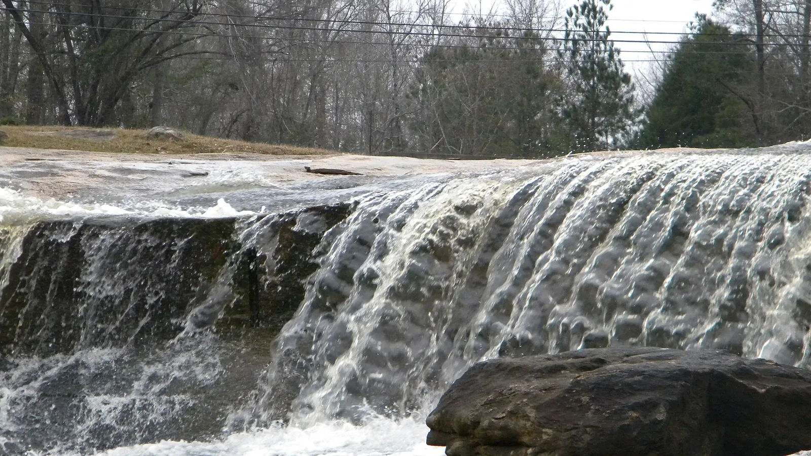 Water spilling over granite ledges at Flat Rock Park in Columbus.