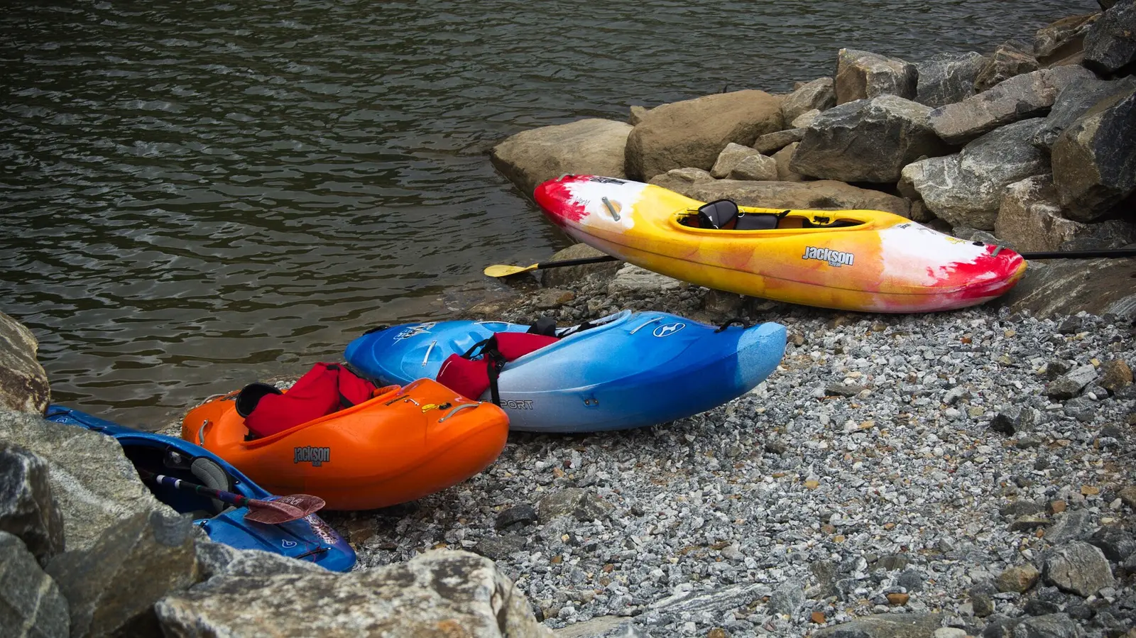 Whitewater kayaks pulled up on the rocky bank of the Chattahoochee River in Columbus.