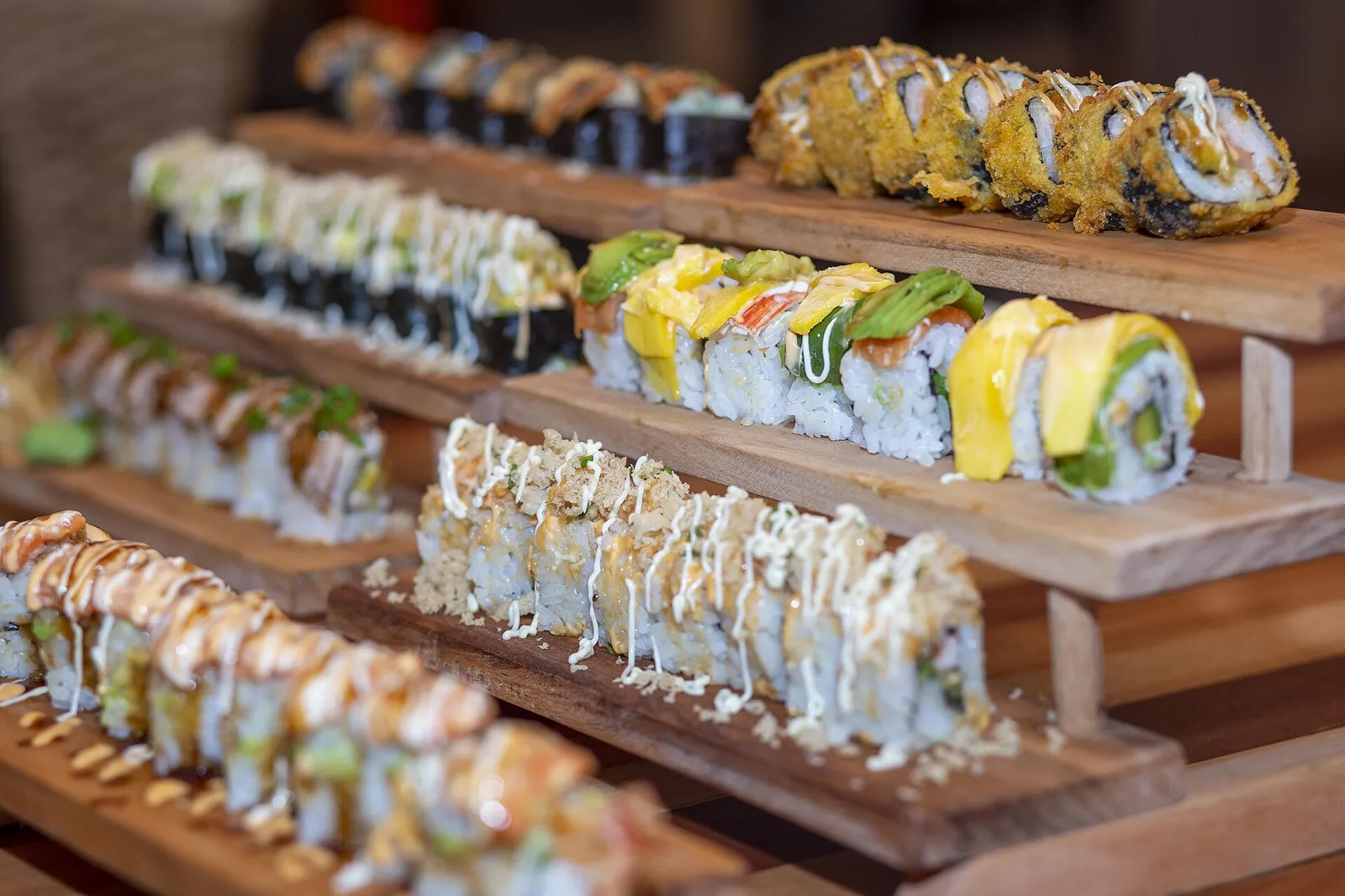 Sushi rolls on a wooden stand. The photo was not taken at a Columbus restaurant.