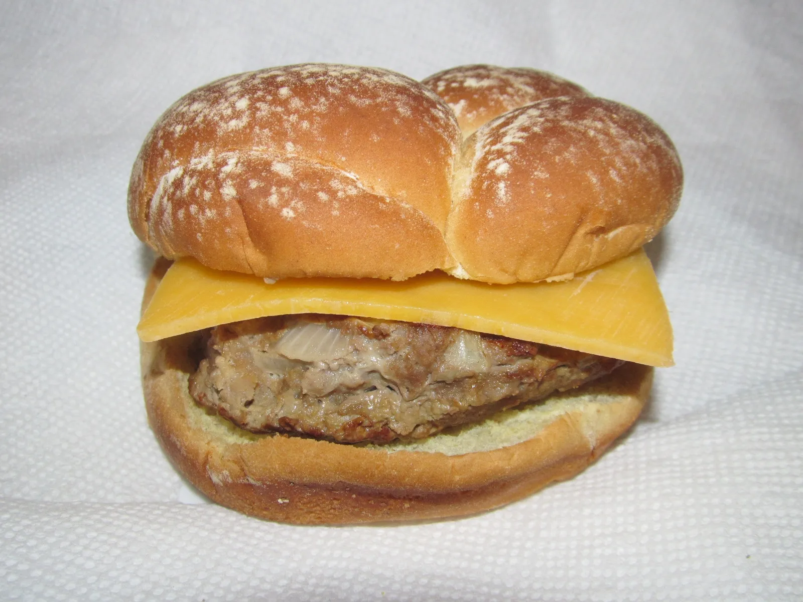 A cheeseburger on a bun. The photo was not taken at a Columbus restaurant.