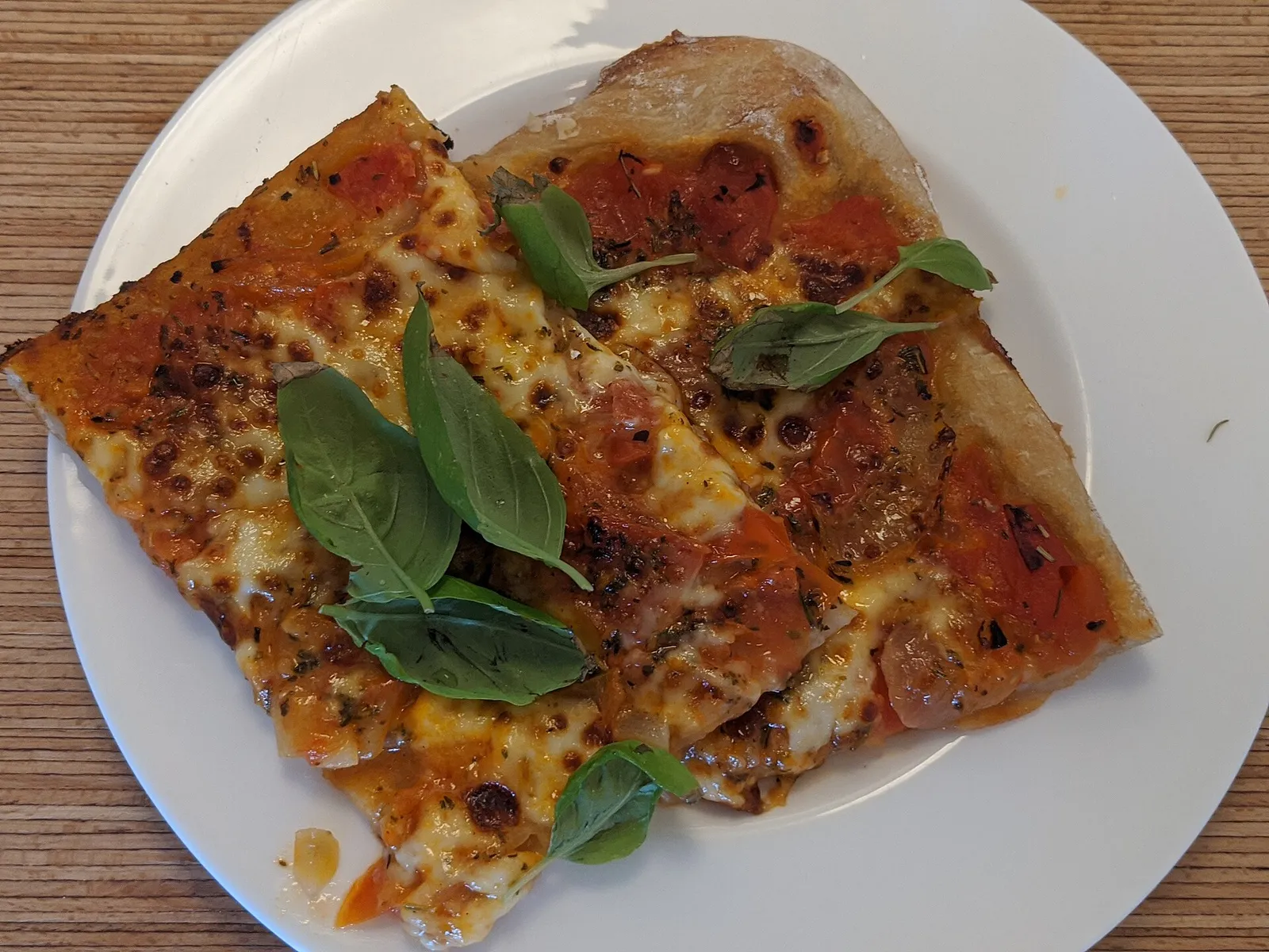 A margherita pizza on a plate. The photo was not taken at a Columbus restaurant.
