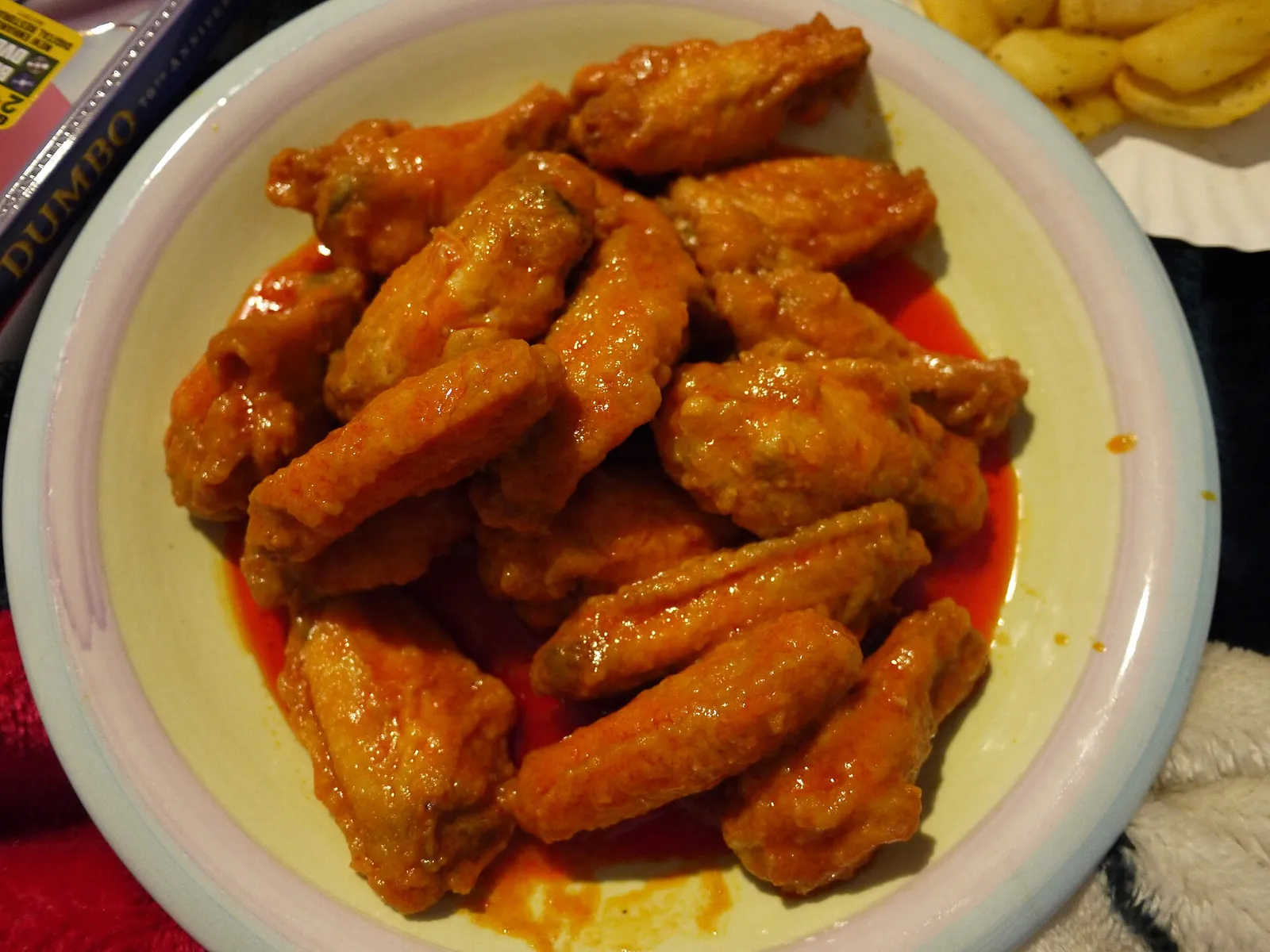 A plate of Buffalo-style chicken wings in hot sauce.